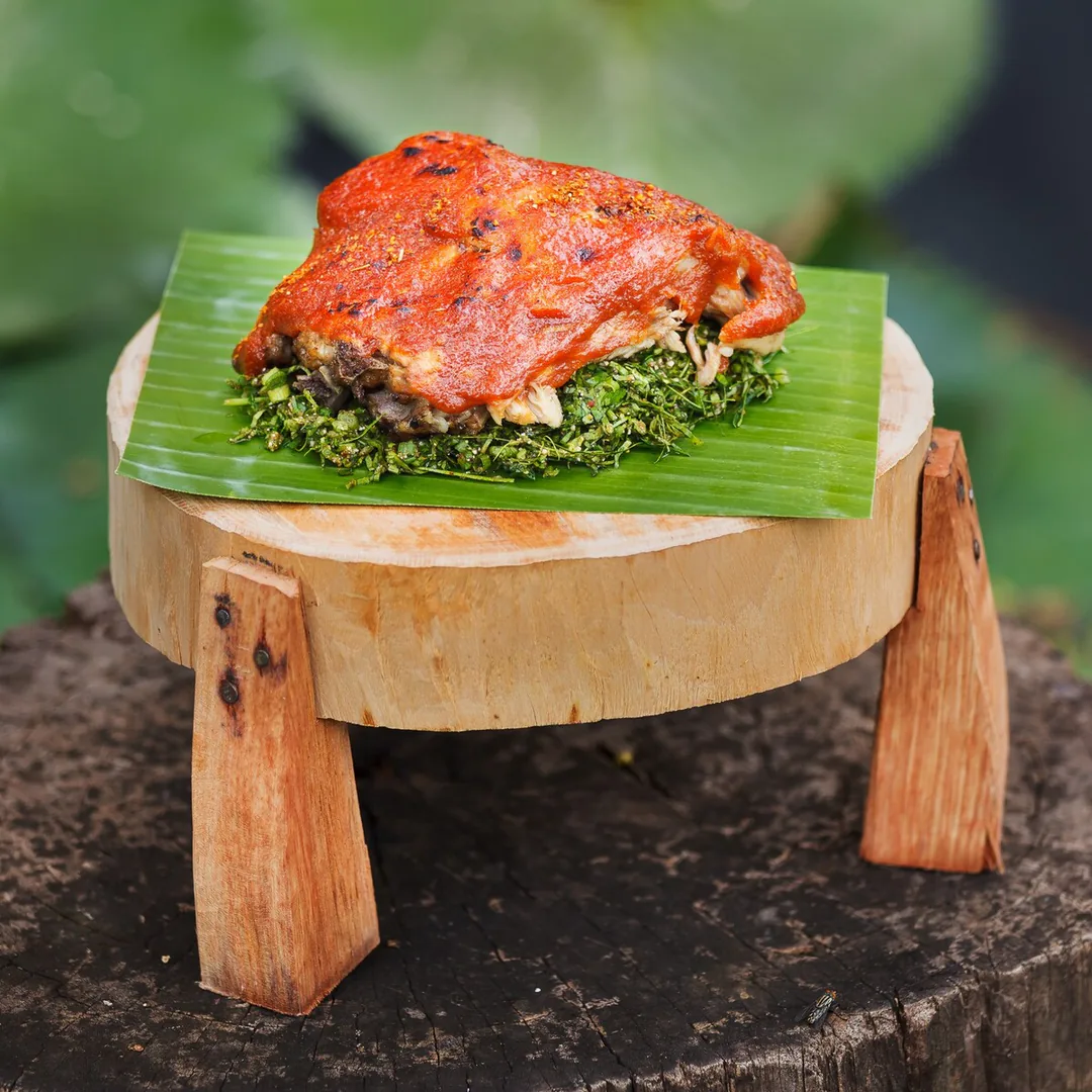 Phed Makkham — grilled pork glazed in tamarind and chilli, served on a banana leaf