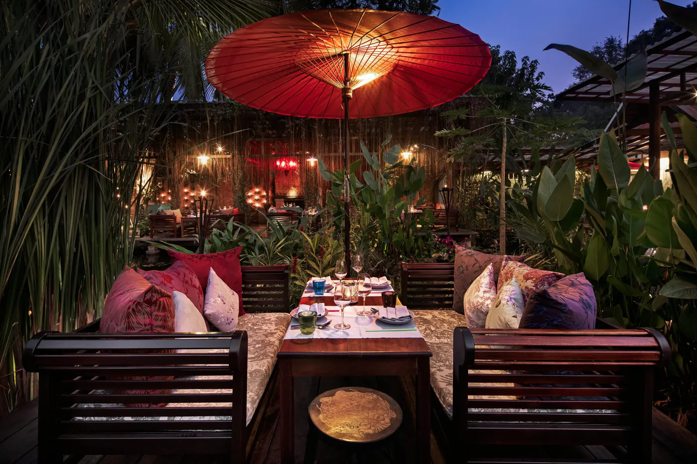 The Bua Kham Table set over the lily pond by candlelight